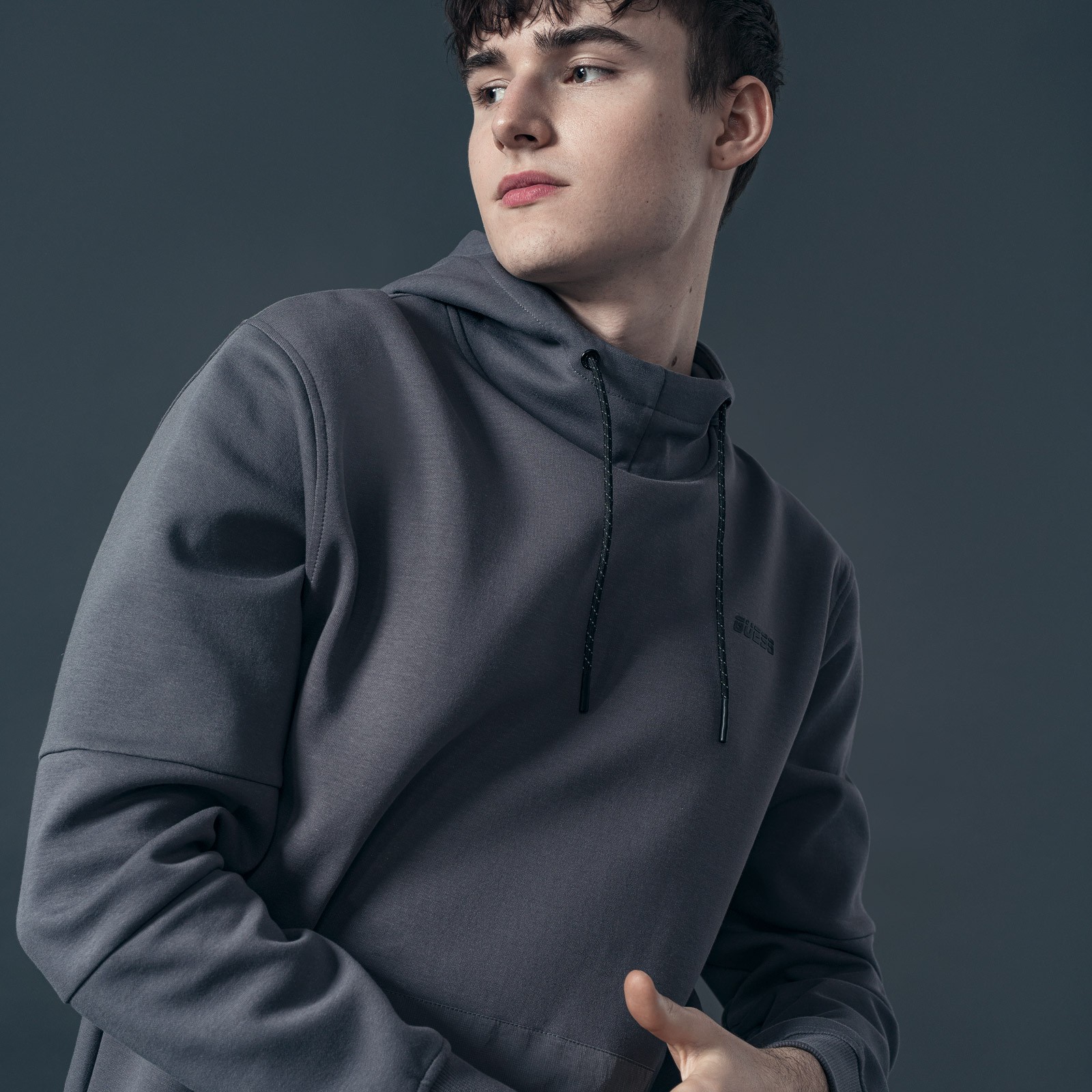 Graphic of a typography specimen showing the alphabet and numerals on top of a dark gray background.