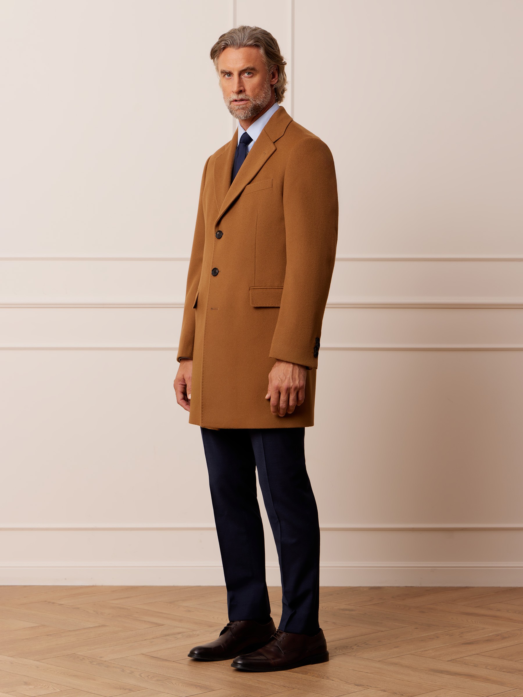 Graphic of a typography specimen showing the alphabet and numerals on top of a dark gray background.